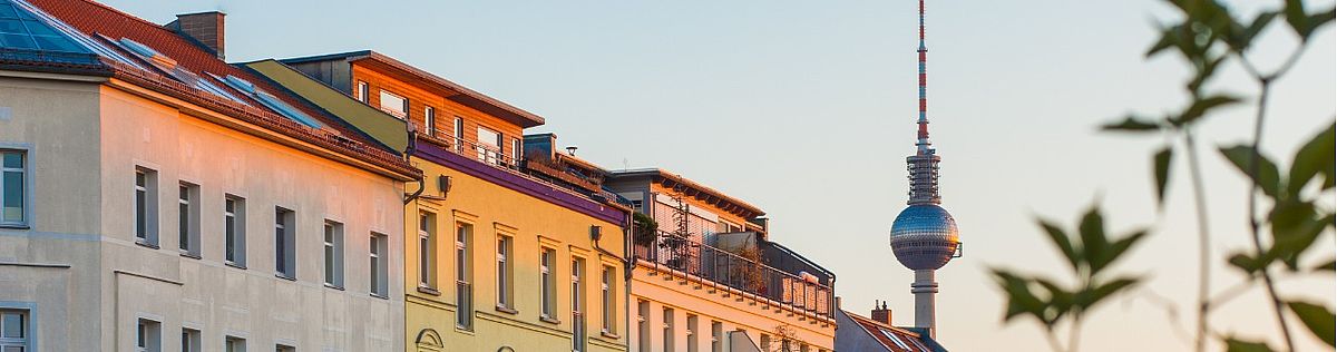 Front of houses, in the background the Berlin television tower